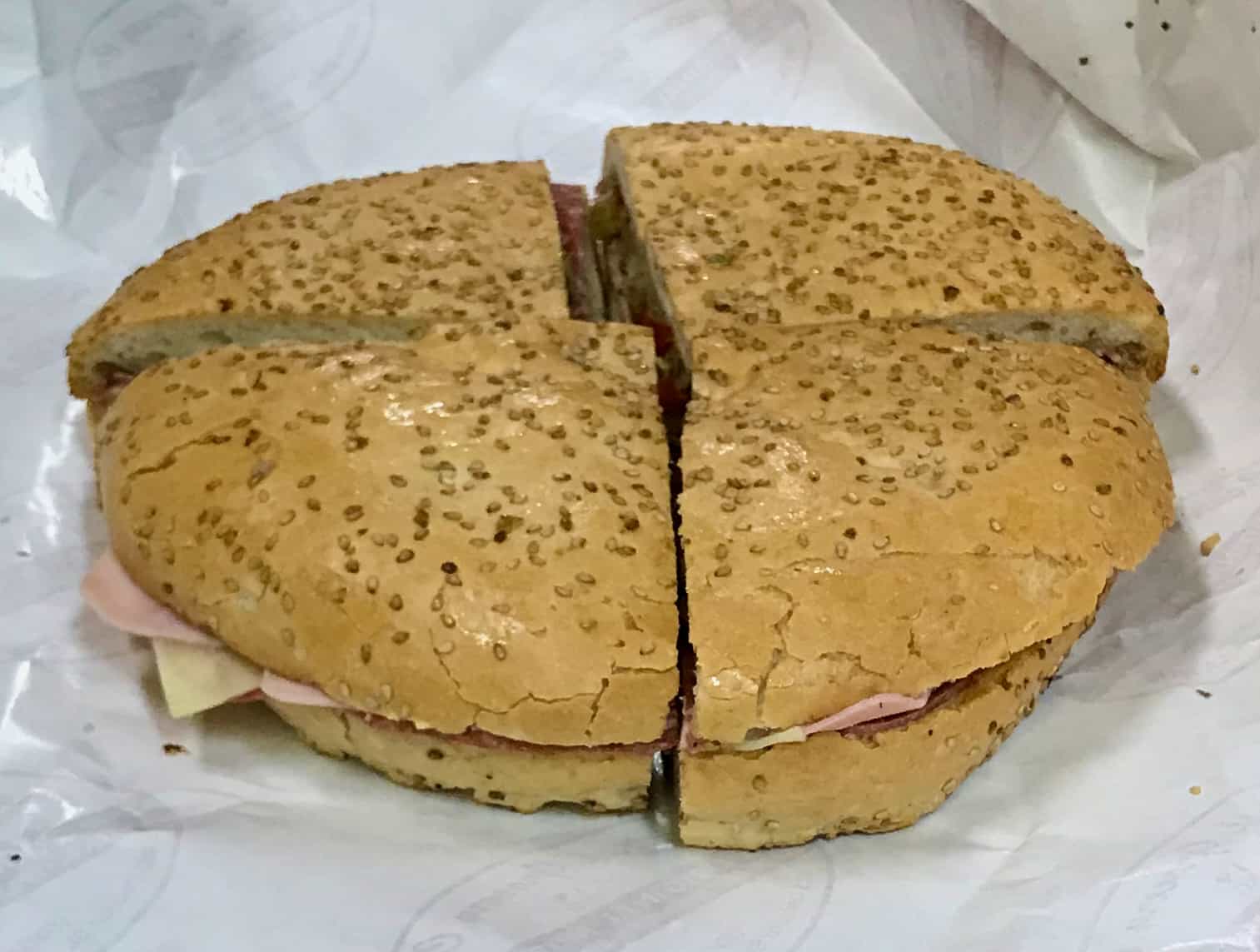 A muffuletta sandwich cut into four sections